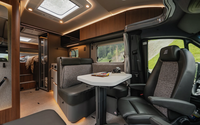 Bathroom in the HYMER B-ML T motorhome with white toilet, wash basin and separate shower with wooden slatted frame