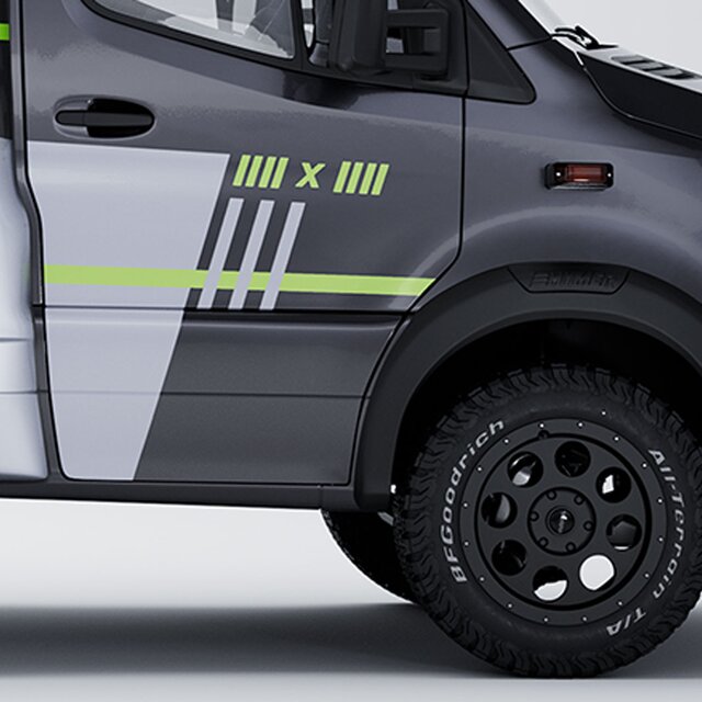 Side view of the front axle with black rims, all-terrain tyres, 4x4 neon green decals, and dark cab